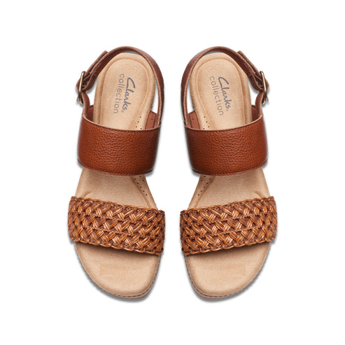 Pair of brown strappy sandals with a woven toe strap and ankle buckle