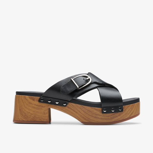 Black leather cross strap clog with a buckle and wooden platform heel.