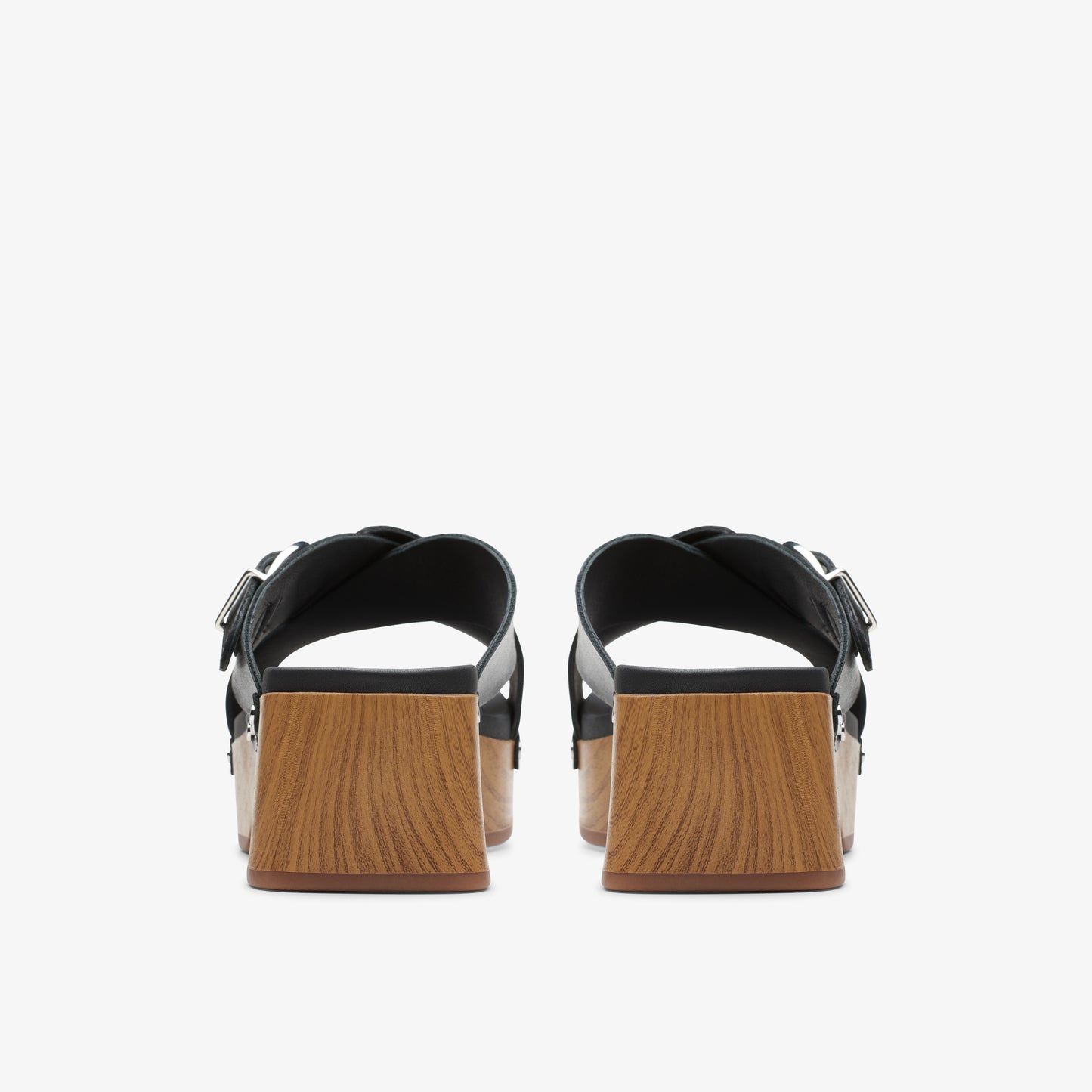 Back view of black platform sandals with adjustable straps and light-brown block heels.