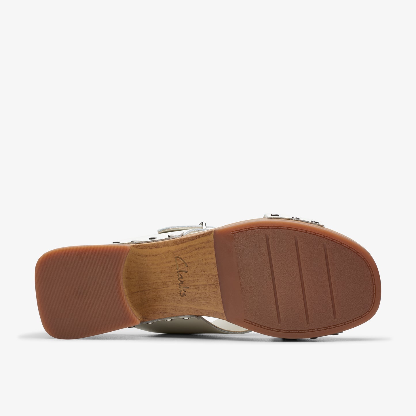 Bottom view of a sandal with a brown sole showing lines on the heel.