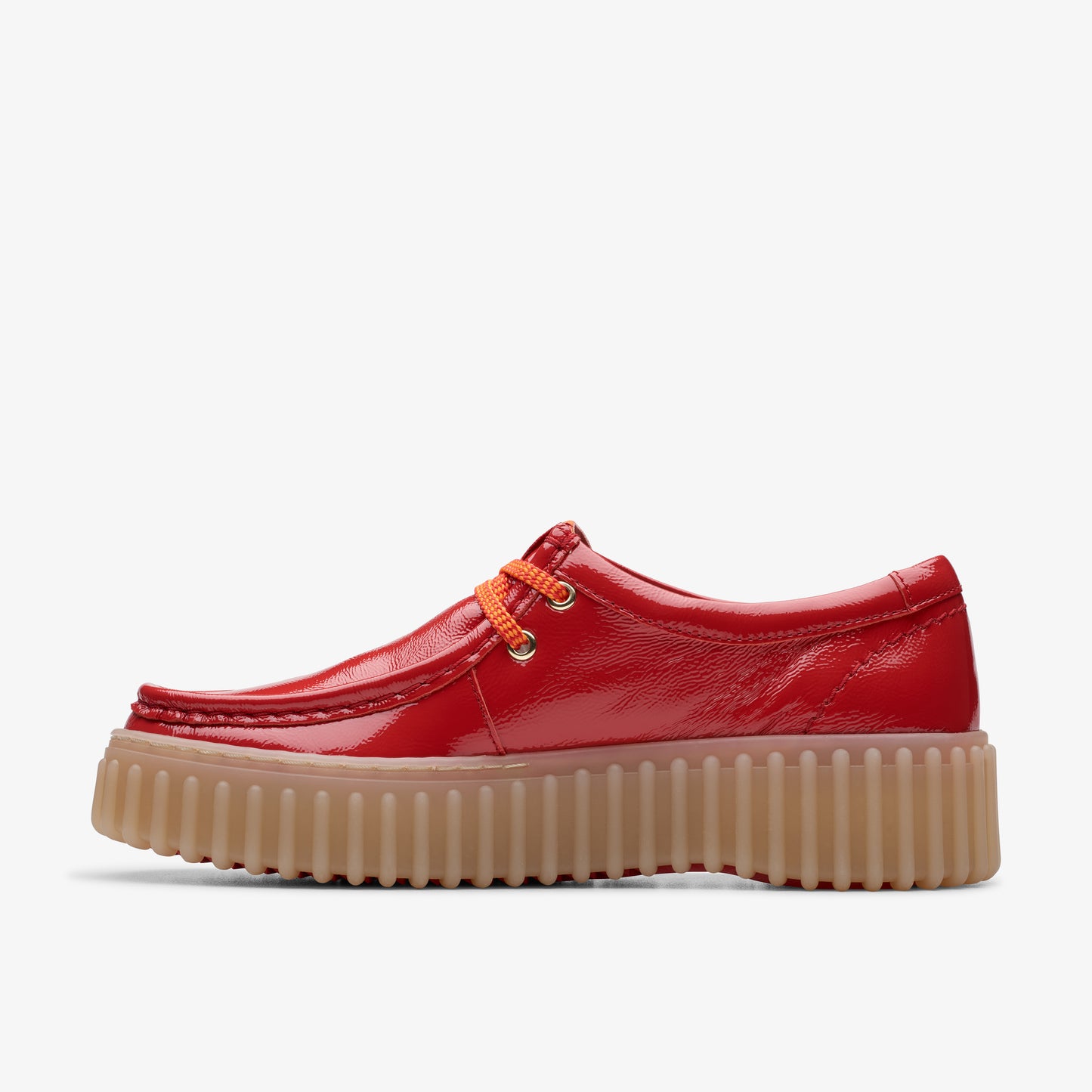 Red patent leather shoe with orange laces and a tan ridged sole.