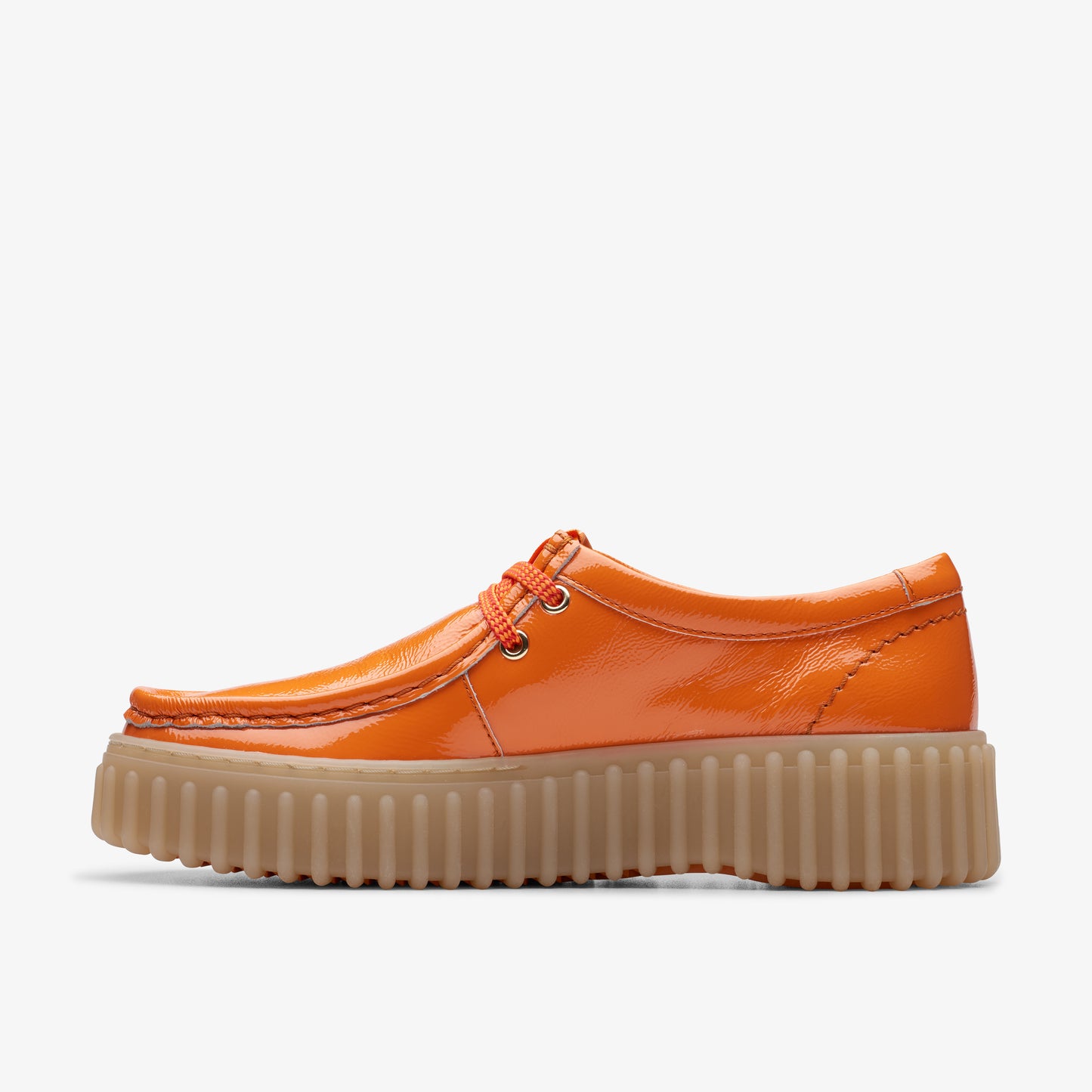 Side view of an orange, patent leather moccasin-style shoe with a thick, ridged sole.