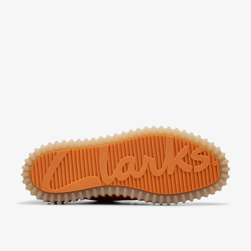 Orange shoe sole with tan edges displaying the raised-letter word "Clarks".