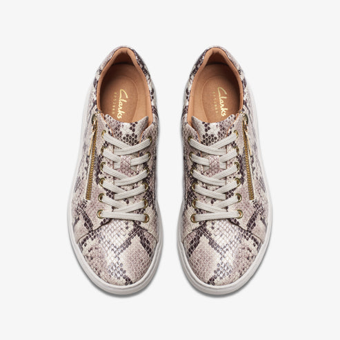 Overhead view of two snakeskin patterned lace-up shoes with gold zippers on either side.