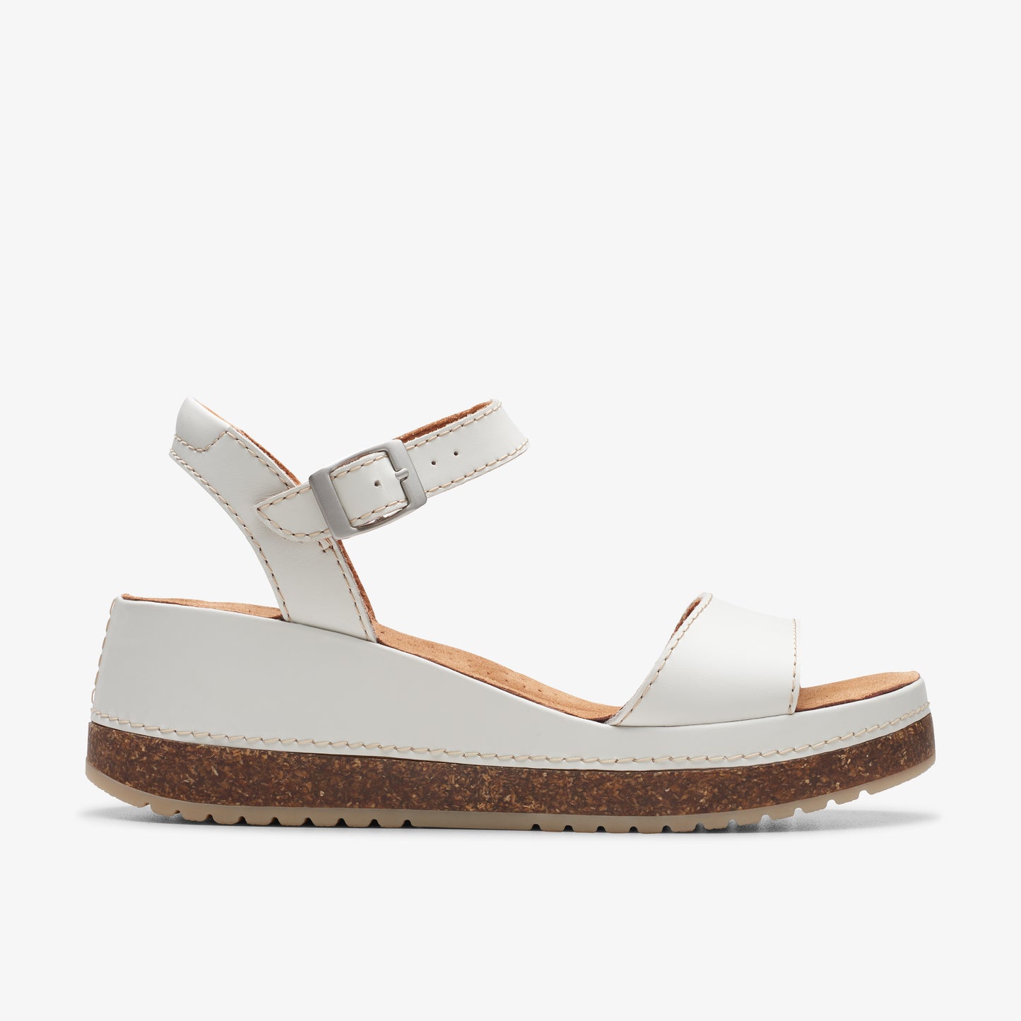 A white platform sandal with ankle strap and cork sole.