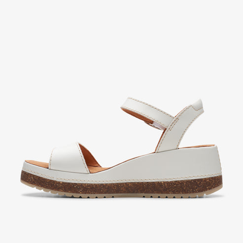 White platform sandal with two straps, one over toes, the other around the ankle.