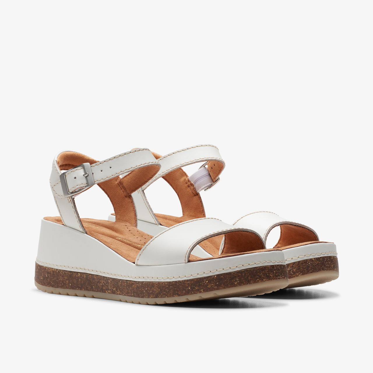 White leather sandals with ankle strap and platform sole.