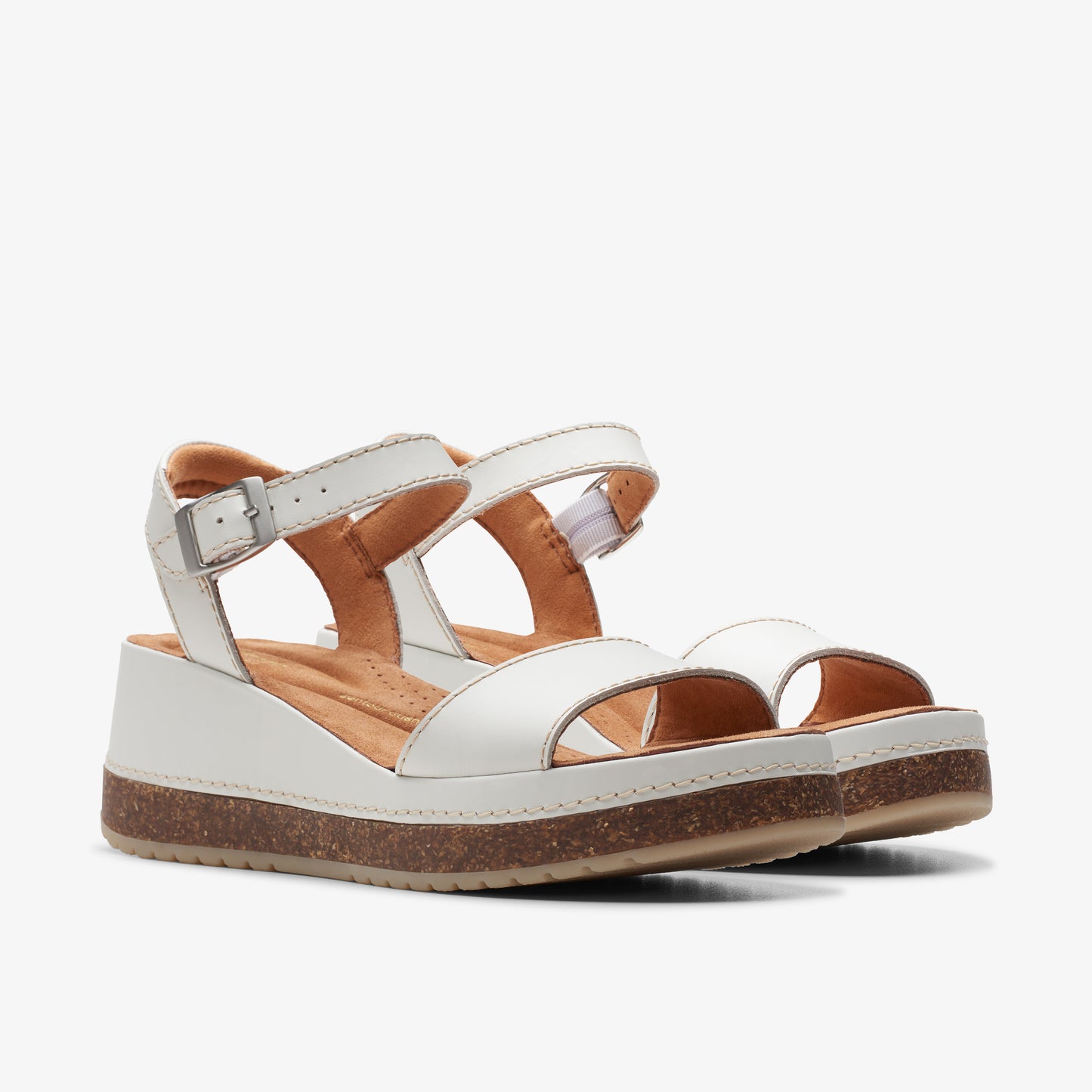 White leather sandals with ankle strap and platform sole.