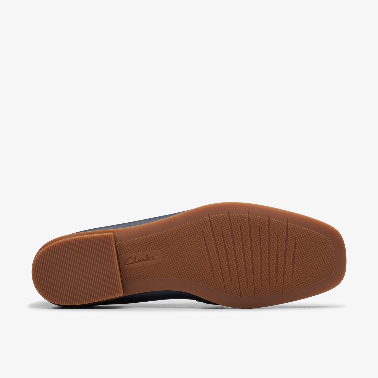Shoe outsole with brand logo, a block heel, and treads.