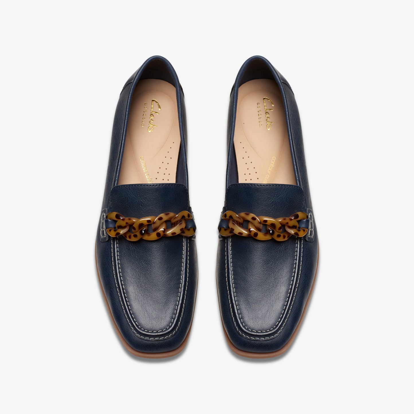 A pair of navy-blue leather loafers, each with a tortoise-shell colored chain detail across the front.
