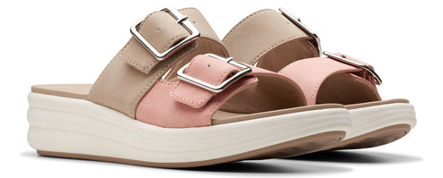 A pair of platform sandals with blush-pink and light beige straps and metallic buckles.