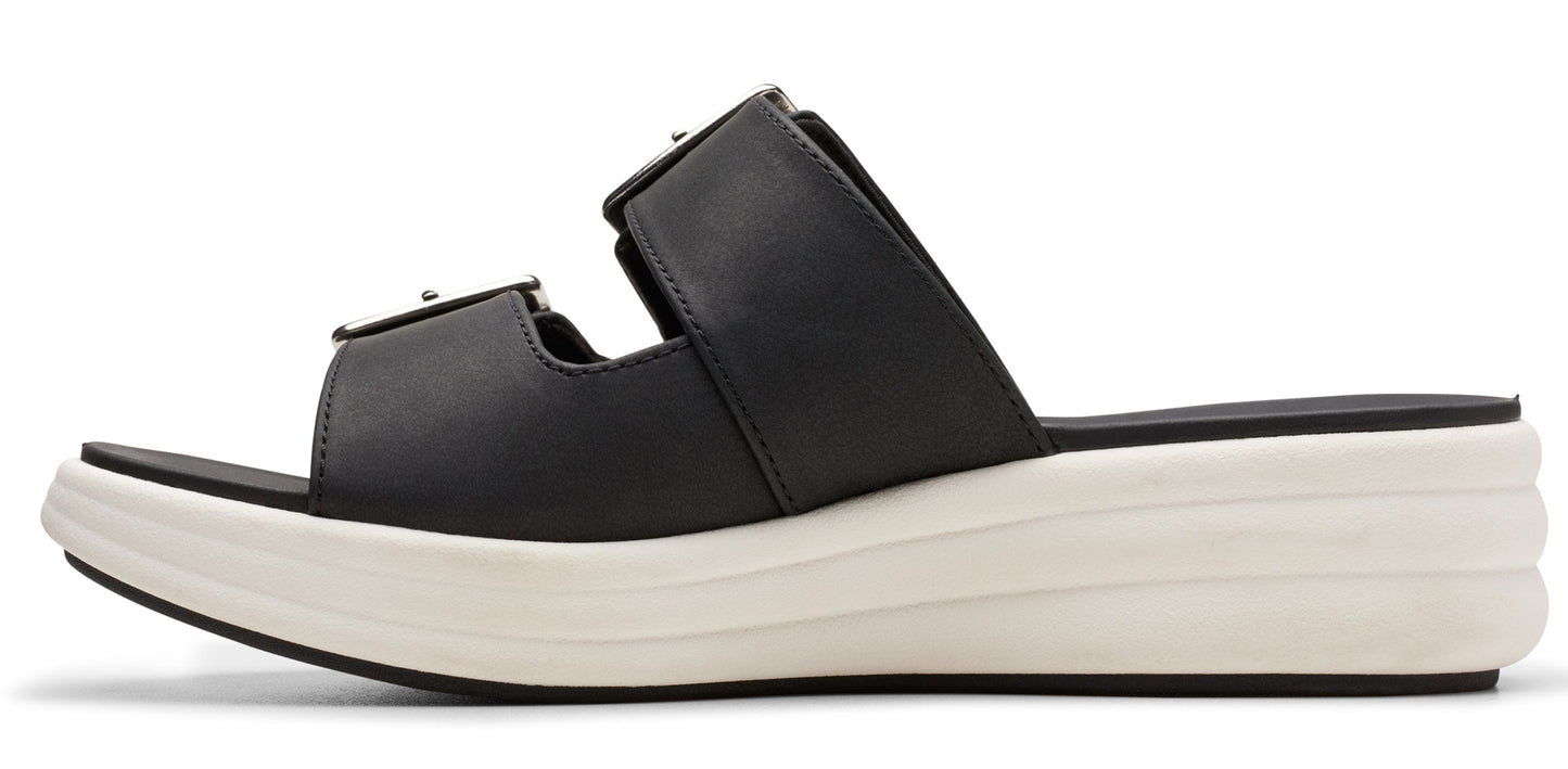 A black sandal with silver buckles and a white platform sole.