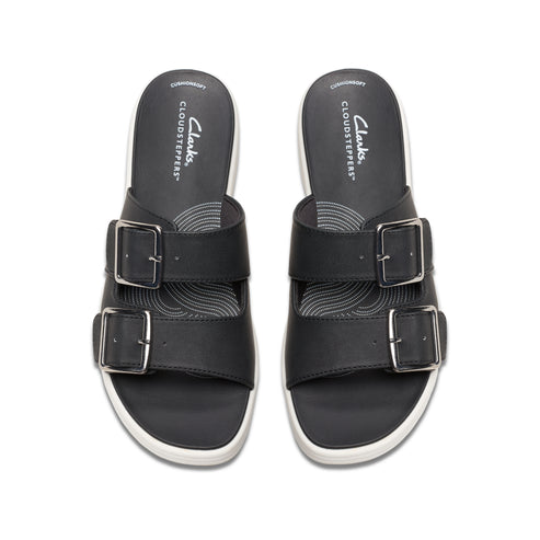 Two identical black slides with two silver buckles each and white soles, as viewed from above.