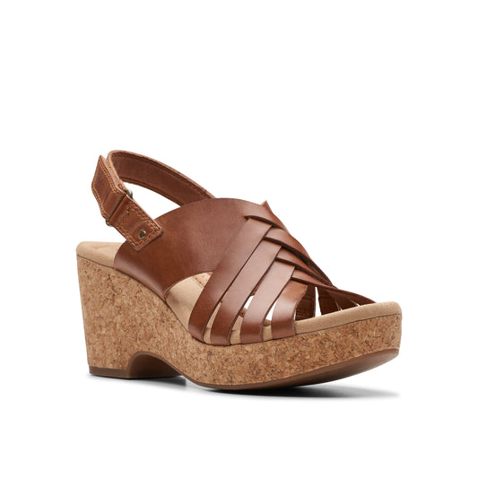 Brown wedge sandal with woven straps and cork platform.