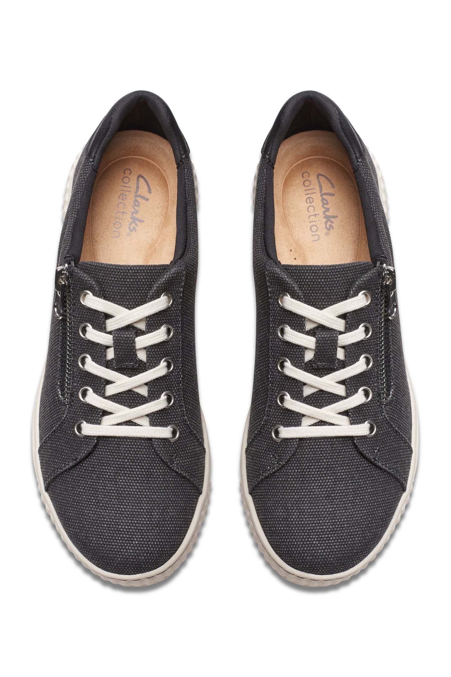 Overhead view of pair of black canvas sneakers with white laces and visible 'Clarks Collection' text inside.