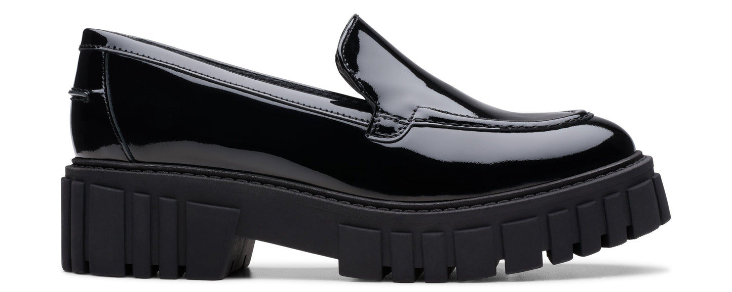 A black patent leather loafer with a chunky lug sole.