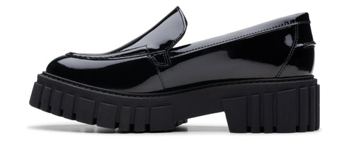 A black patent leather loafer with a chunky lug sole.