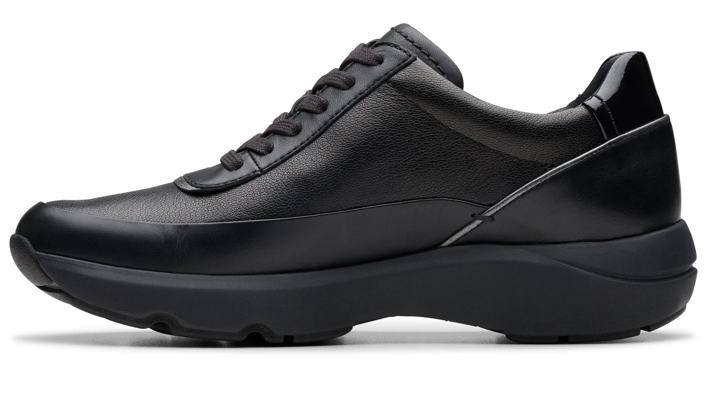 Black leather women's sneaker with black soles and a lace-up closure.