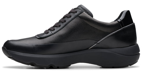 Black leather women's sneaker with black soles and a lace-up closure.