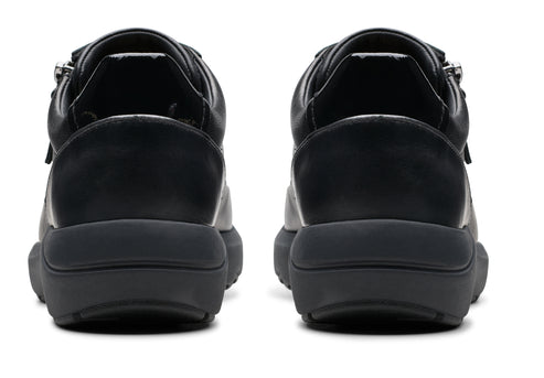 Two black sneakers viewed from the rear showing the heel and ankle support.