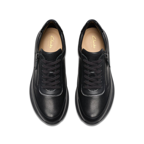 Top-down view of two black leather shoes with laces and zippers.
