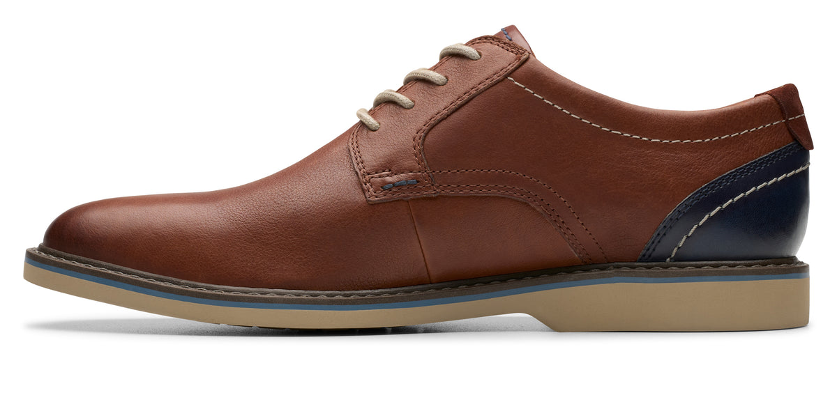 A brown leather lace-up dress shoe with a blue accent on the heel.