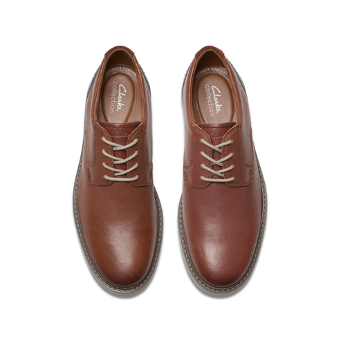 Pair of brown leather oxford shoes with white laces.