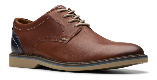 Brown leather dress shoe with beige laces and sole, and blue accent on the heel.