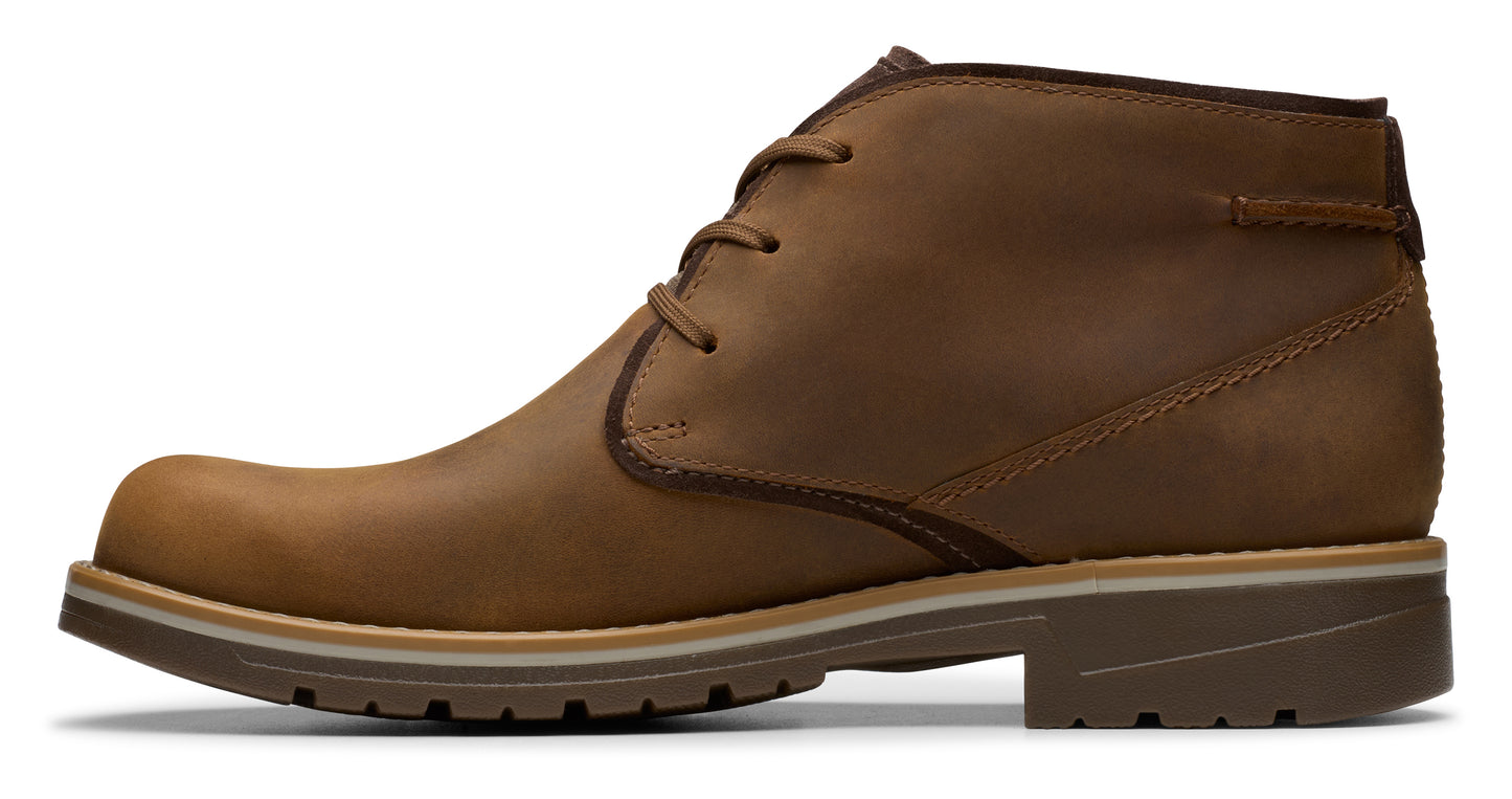 Side view of a brown leather chukka boot with a lug sole and laces.