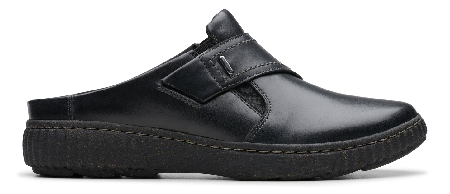 Black slip-on shoe with a wide strap across the top.