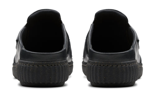 Pair of black slip-on shoes, rear view showing the thick, ridged soles and rounded heel.