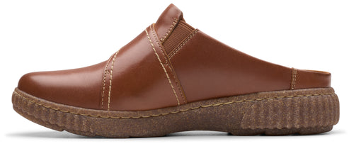 A brown leather clog with crosswise strap detail and ridged sole.