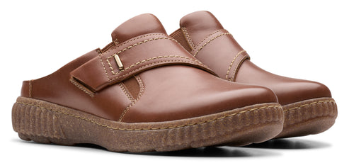 A pair of brown leather mules with a hook-and-loop closure.