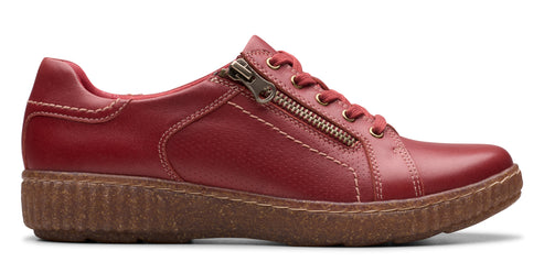 A red sneaker with a zipper on the side.