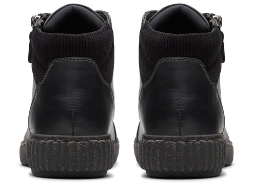 Back view of two black high-top shoes with ribbed collars and ridged soles.