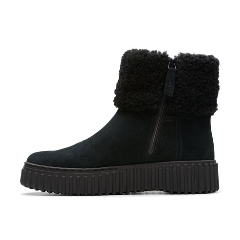 Black suede boot with fluffy wool cuff and lug sole.