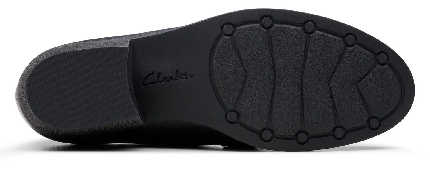 The outsole of a black shoe with the word 'Clarks' etched in the center.