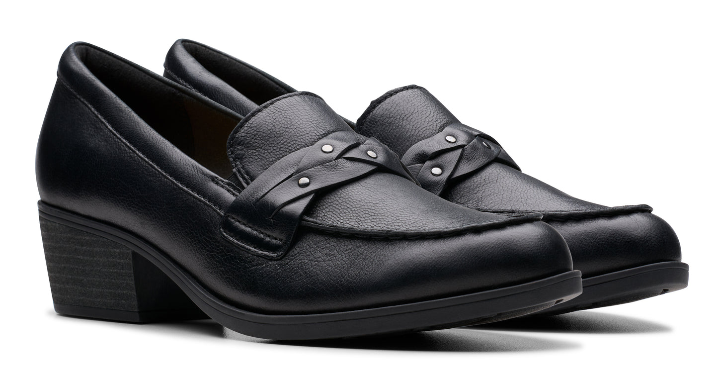 Pair of black leather heeled loafers with decorative strap and studs.