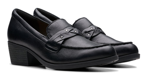 Pair of black leather heeled loafers with decorative strap and studs.