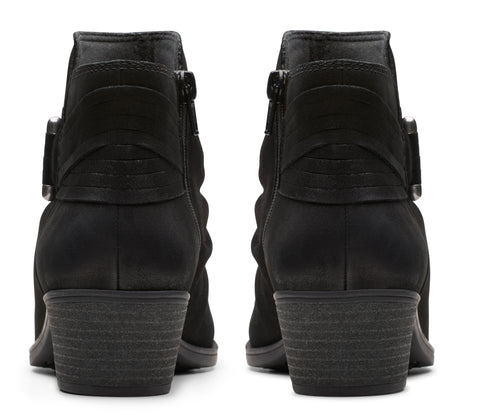 Pair of black ankle boots with block heels and side zipper closures.