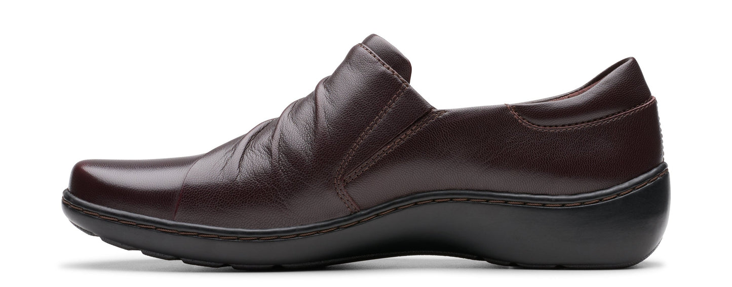 A dark brown leather slip-on shoe with a black sole.