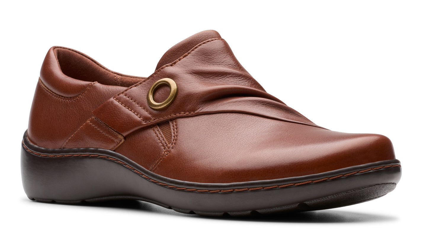 Brown leather shoe with rounded toe and low sole, accented with a gold ring.