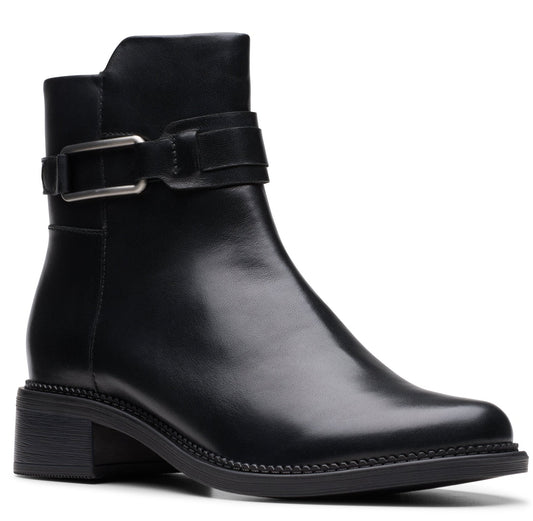 A black leather ankle boot with a low heel and a decorative buckle strap.