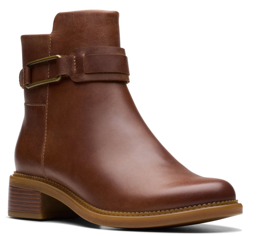Brown leather ankle boot with block heel and buckle strap.