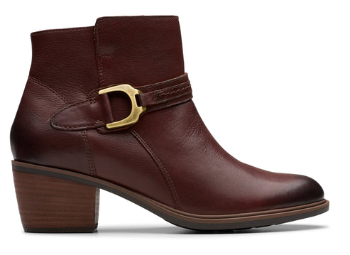Ankle-high, dark-brown leather boot with block heel and gold-colored buckle detail.