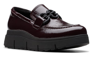 Burgundy patent leather platform loafer with black chain detail and chunky black sole.