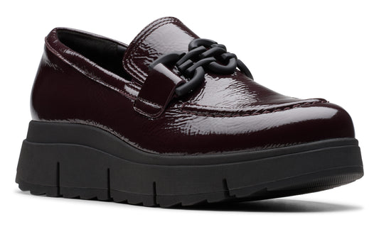 Burgundy patent leather platform loafer with black chain detail and chunky black sole.