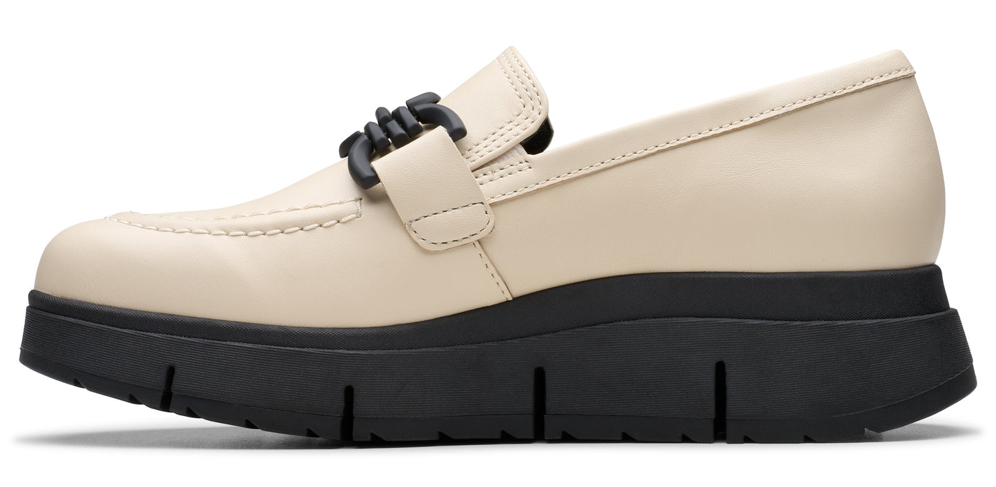 Cream-colored women's loafer with a black chain detail on the vamp and a chunky black sole.