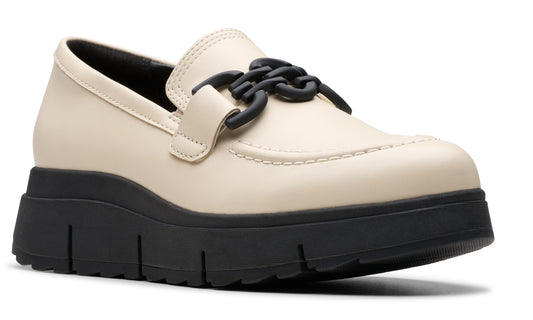 Beige loafer with a black chain and a black platform sole.
