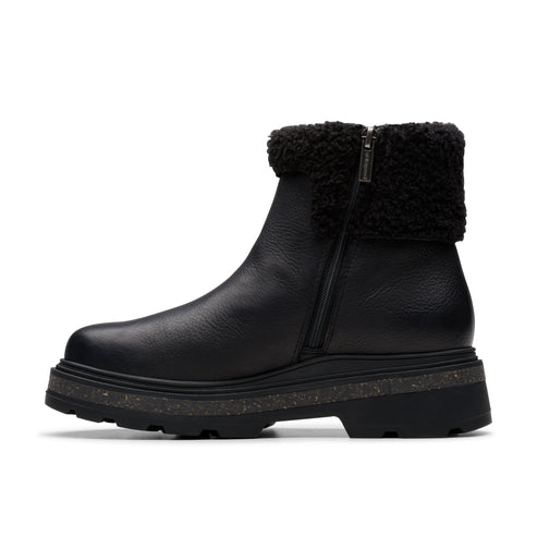 Black ankle boot with faux fur collar and side zipper.